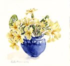 Primroses in blue vase